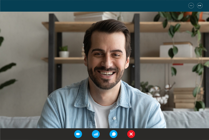 Head shot portrait device screen view smiling young man chatting online at home, talking with friends or relatives, using webcam and social media app, engaged in virtual conference, having fun