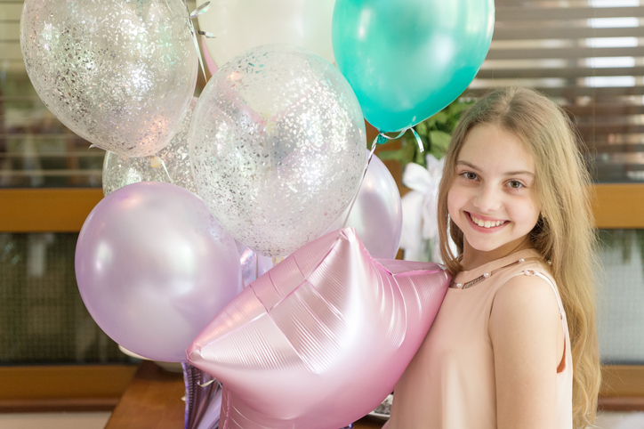Smiling beauty. Girl with balloons celebrate birthday in cafe. Birthday party. Ideas how to celebrate birthday for teens. Girl smiling child hold bunch balloons. Her special day. Birthday celebration.