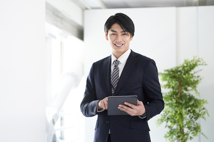 Japanese male businessman smiling and looking at the camera